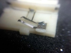 Not the best photo, but this is a closeup of the nearly-broken wiper brushes. I fixed it with a drop of super glue.